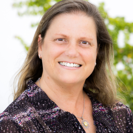 Headshot of Sharon Bacharach in a purple shirt