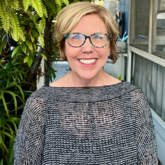 Donna Cecil in glasses and gray top