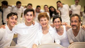 Multi-generational Jewish family smiling together at an American Jewish University community event.