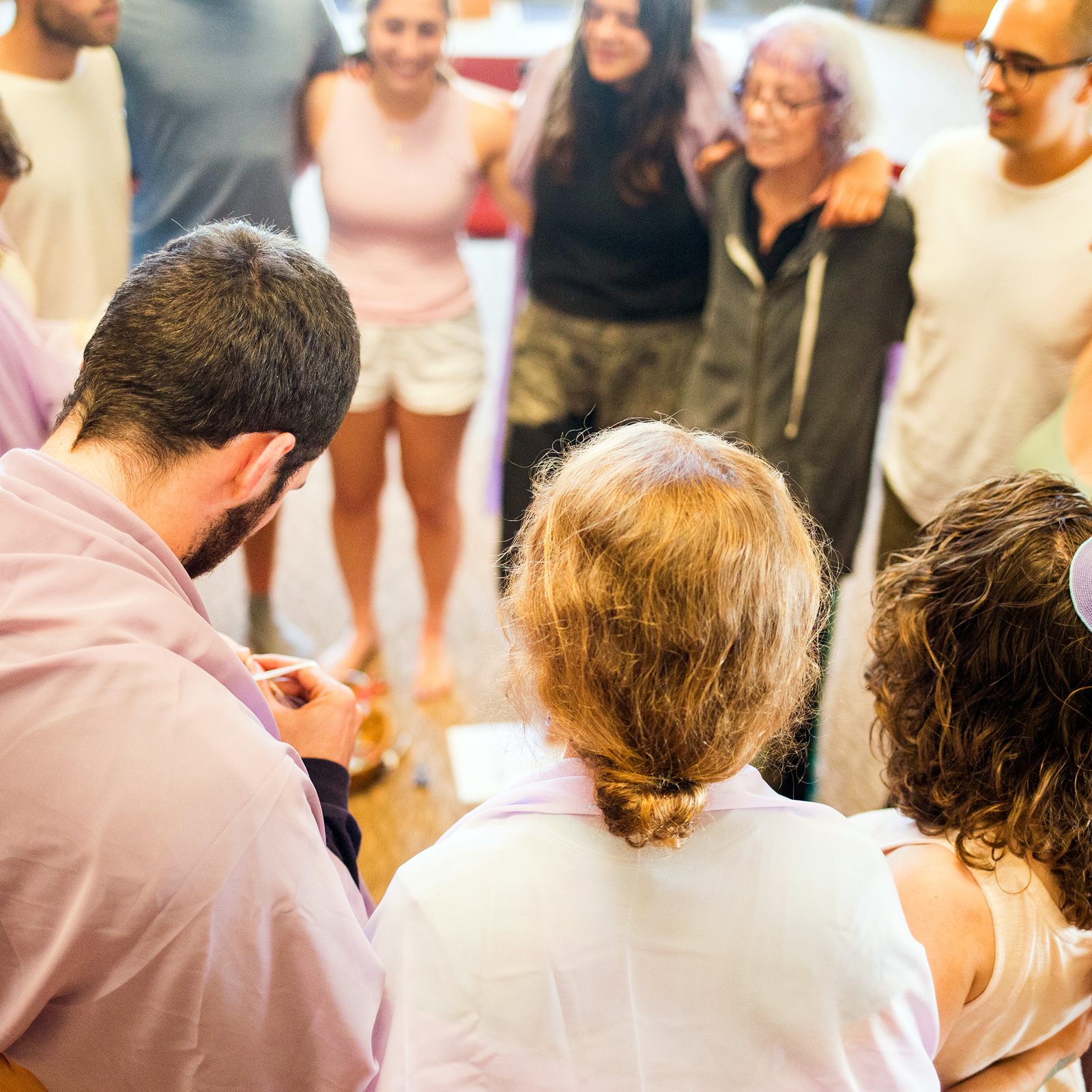 Young adults standing in a circle together during a group activity at the Ziering Brandeis Camp Institute.”