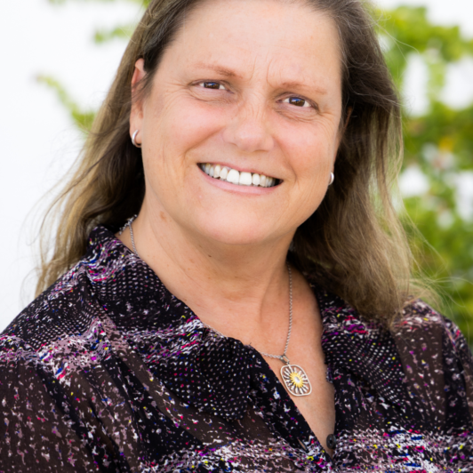 Headshot of Sharon Bacharach in a purple shirt