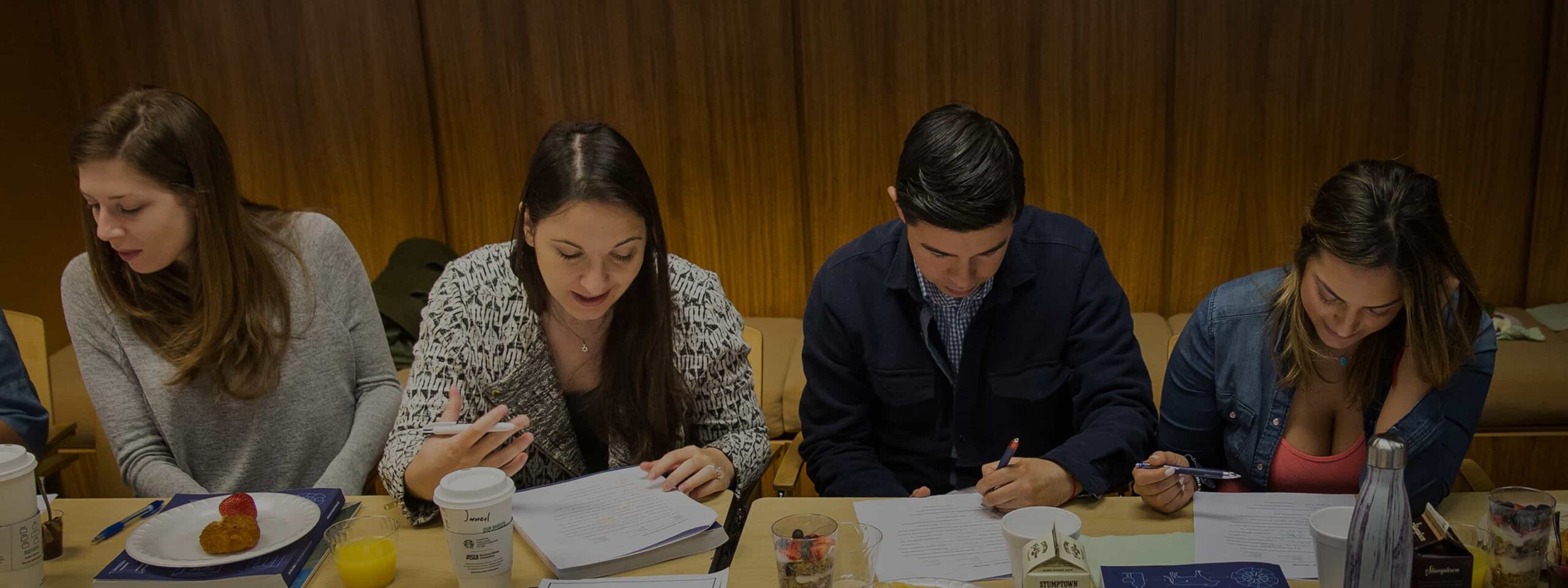 Students studying and taking notes together during an introductory Judaism class.