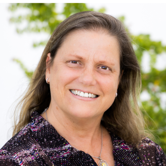Headshot of Sharon Bacharach in a purple shirt