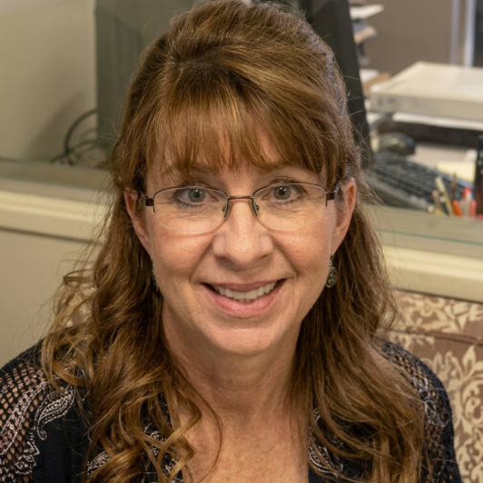 Headshot of Marcy Davidson with glasses