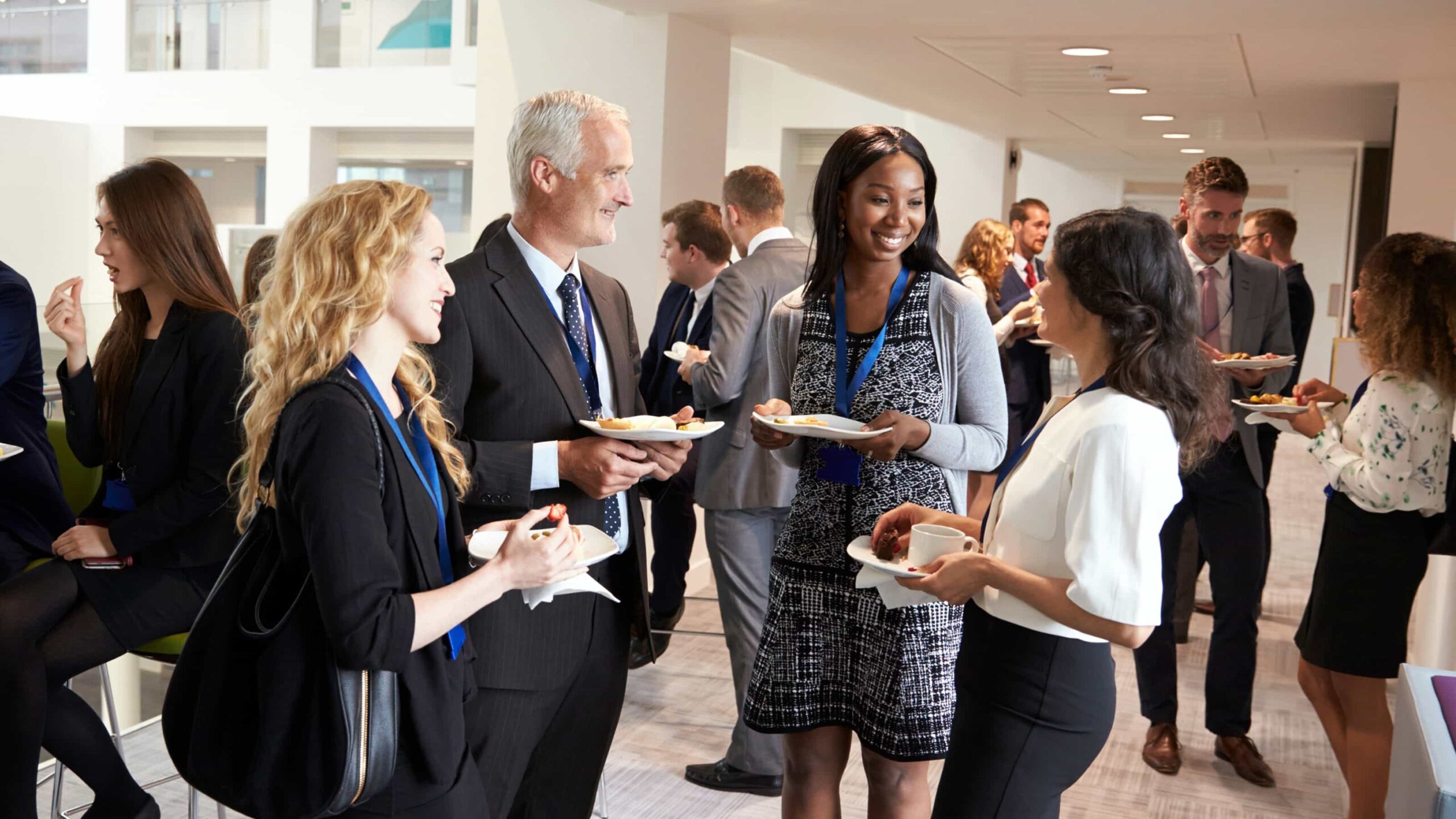 Professionals networking and conversing at a social event for the 2050 Institute.