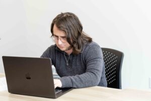 A man at a desk on his laptop.