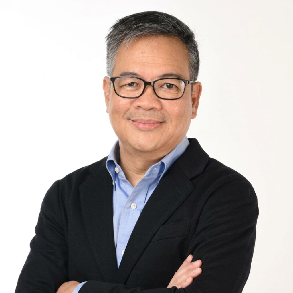 Heatshot of Patrick John Ray Carpio in glasses, a blue shirt, and a black jacket