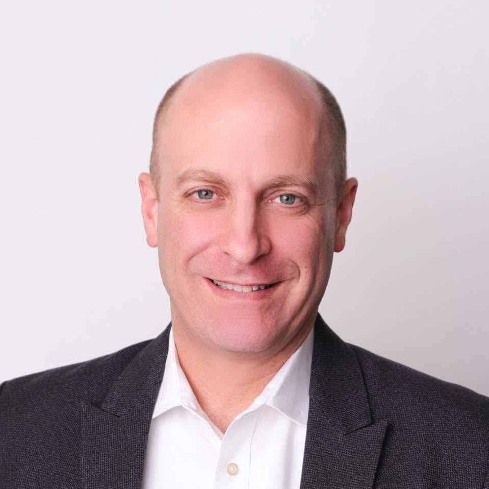 Headshot of Gidi Grinstein in white shirt and black jacket