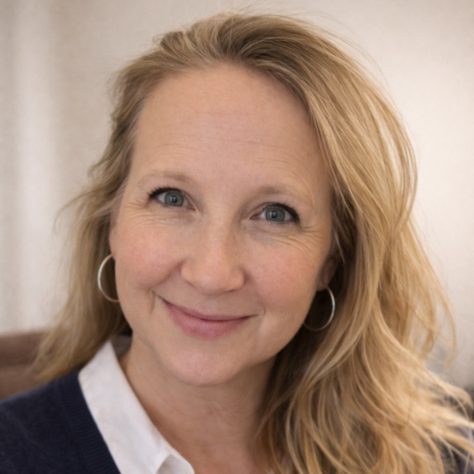 Headshot of Lisa Samick in a white collared shirt and blue sweater