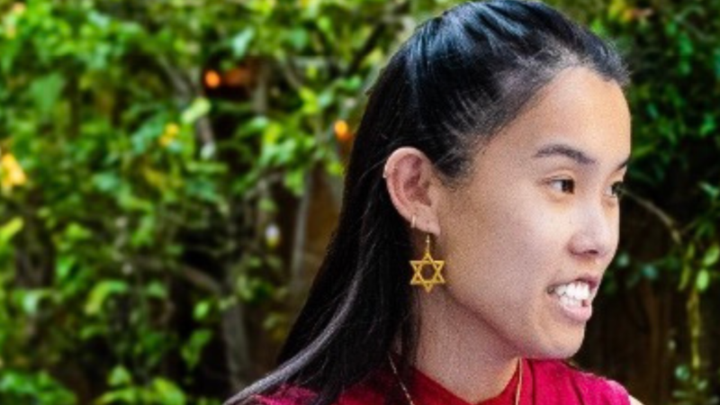 A side profile of Vanessa Bloom wearing a red shirt and a gold Jewish star earring