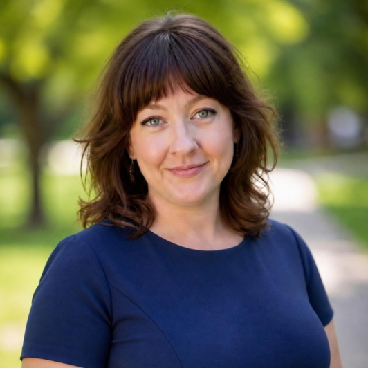Natasha Newman in a dark blue t shirt with trees in the background