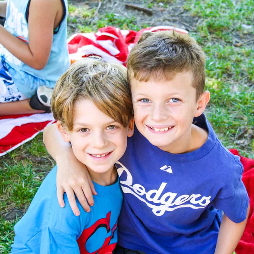 Two little boys hug and smile