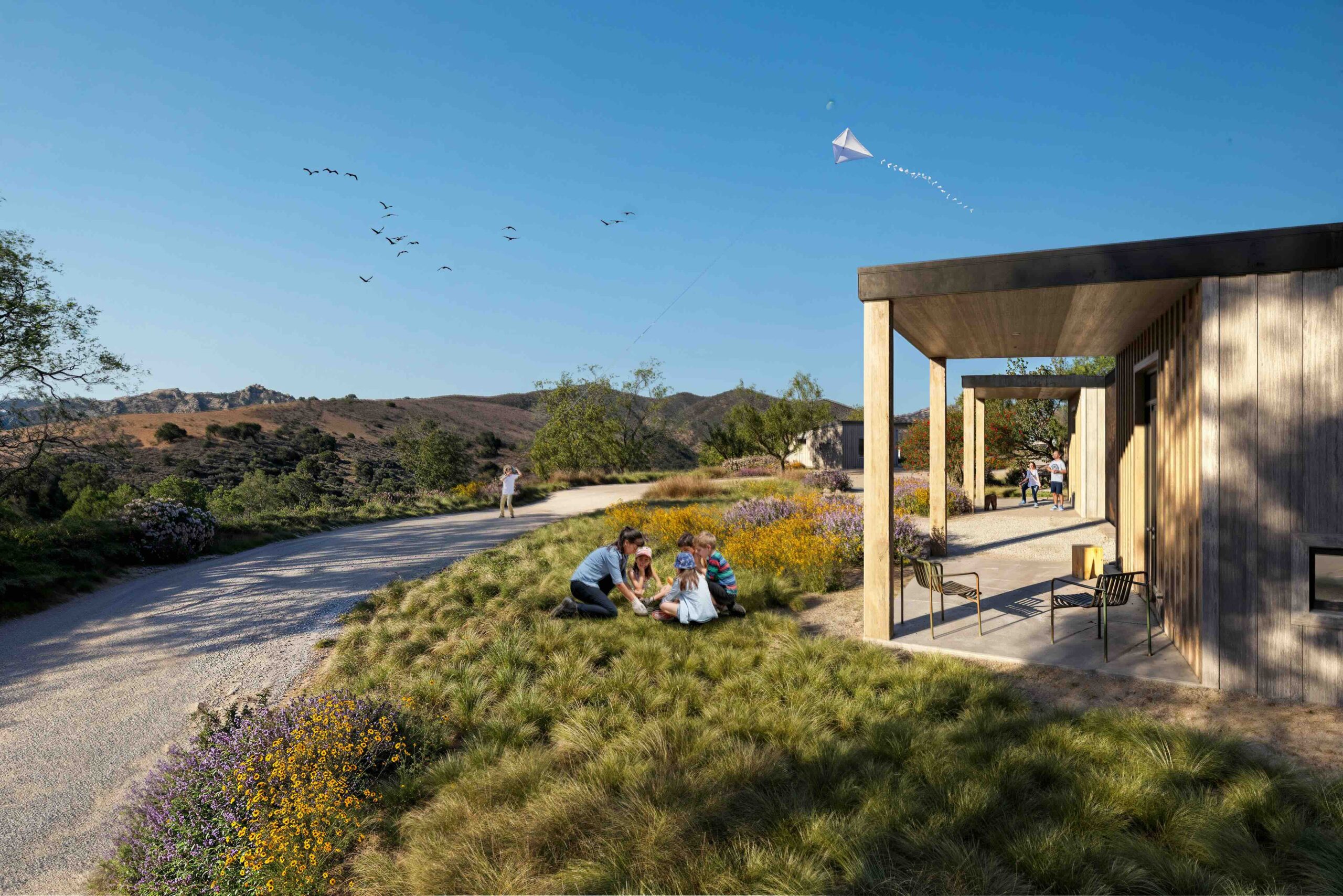 A mockup of a patio with a road outside and two kids playing in front of it for a future Camp Alonim building.