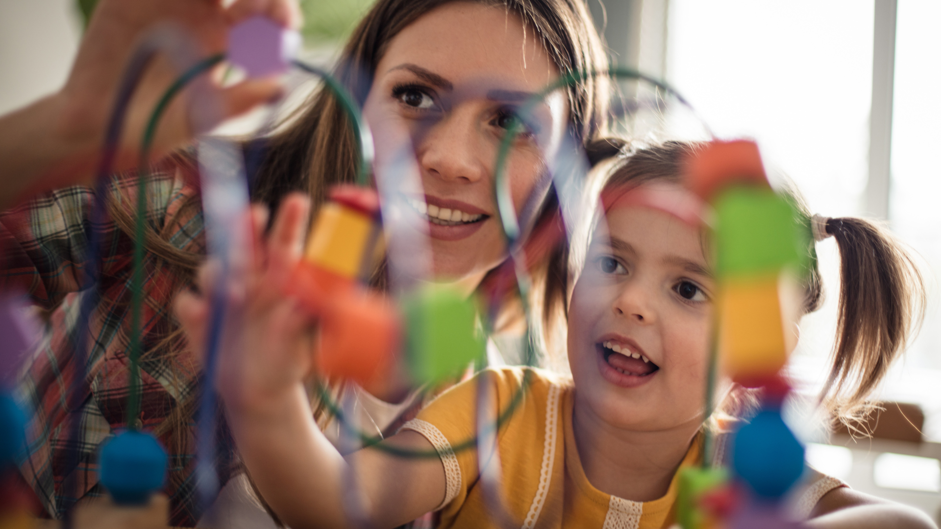 A special education teacher plays with a small child