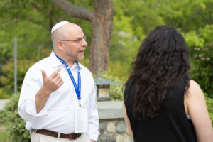 A Masor EdD student talks with a group outdoors