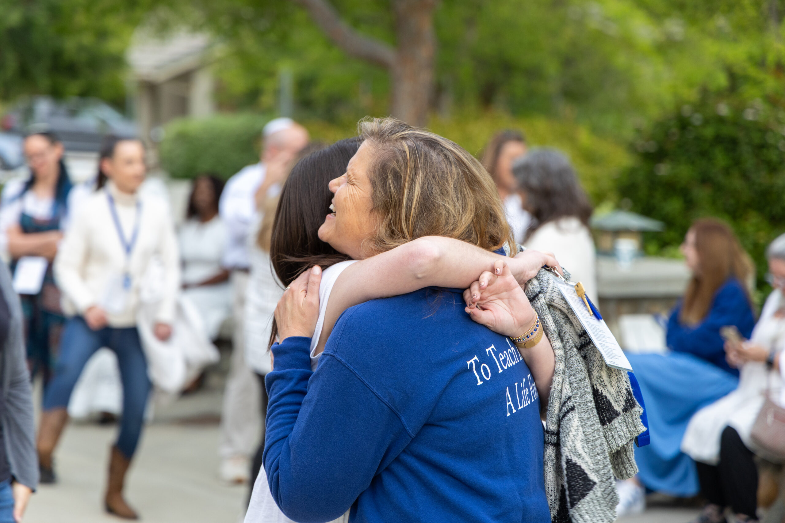 Masor School students hugging at an event