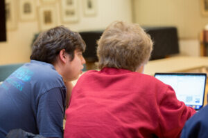 2 JLE students working together on a laptop